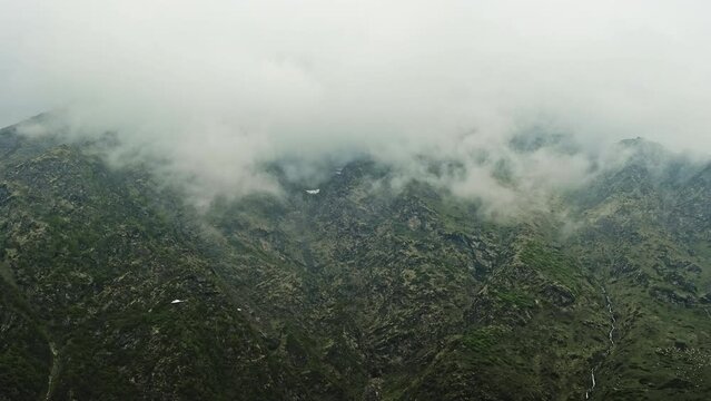 Aerial view of helicopters flying over the foggy, green, and beautiful Uttarakhand valley in the Himalayas of India. Different shots of helicopters over the Himalayan valley near Kedarnath temple.