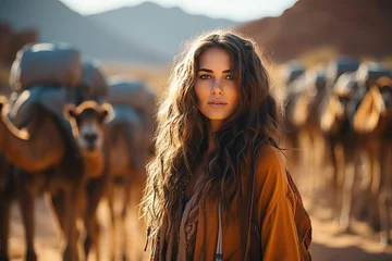 Zelfklevend Fotobehang Portrait of a tourist girl near camels in the desert. © Niko_Dali