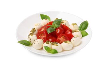 Plate of tasty Caprese salad with mozzarella, tomatoes, basil and pesto sauce isolated on white