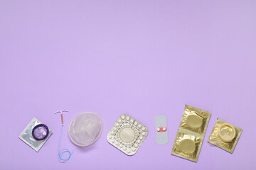 Contraceptive pills, condoms and intrauterine device on lilac background, flat lay and space for text. Different birth control methods