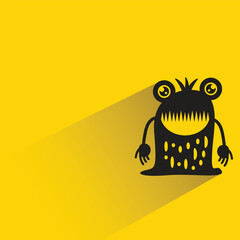 funny monster with shadow on yellow background