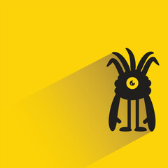 funny monster with shadow on yellow background