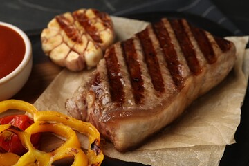 Delicious grilled beef steak with vegetables on table, closeup
