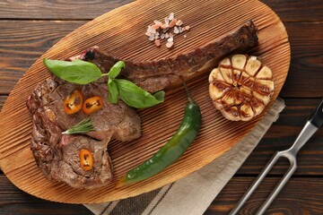 Delicious fried beef meat served on wooden table, flat lay