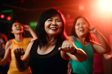 Middle-aged Asian women enjoy fun dancing, aerobics, and fitness classes. Dance class, zumba, karate