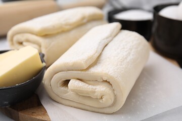 Raw puff pastry dough on table, closeup