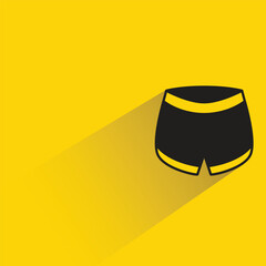 Fototapeta na wymiar short pants with shadow on yellow background