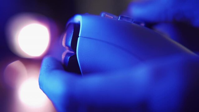 Professional gamer playing shooting game with game controller