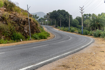 twisted tarmac highway isolated with nil traffic at morning from flat angle