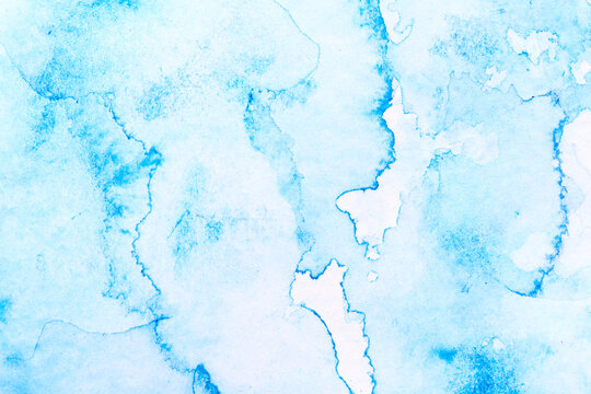 Abstract liquid art background. Blue watercolor translucent blots on white paper. © amixstudio