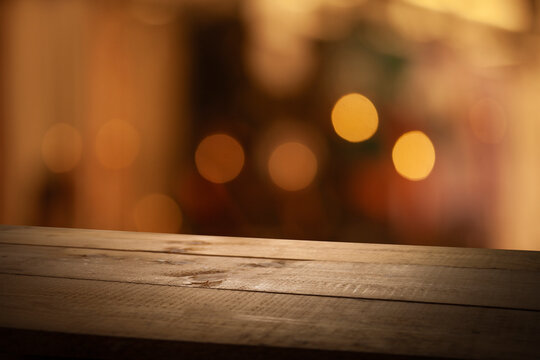 Empty beautiful wooden tabletop and blurred bokeh modern cafe interior background in clean and bright, banner ready for product installation
