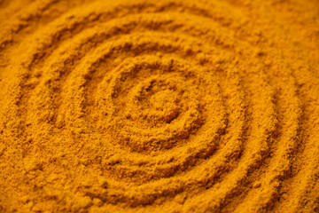 Heap of turmeric powder. Condiment or dietary supplement.
