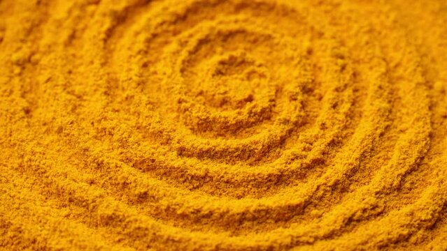 Zoom frame turmeric powder top view, rotate. Condiment or dietary supplement