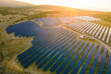 Aerial view of solar energy panels rows in mountain landscape, esg investing