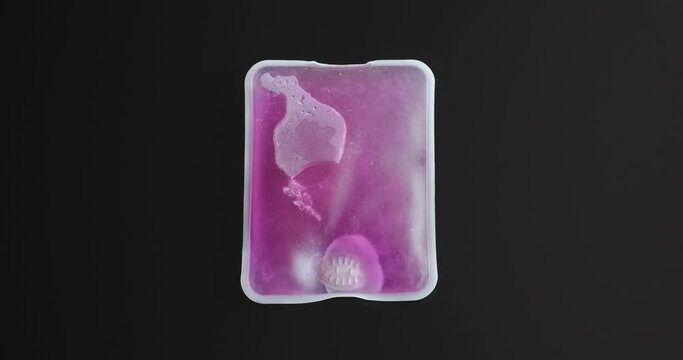 Reusable hand warmer exothermic reaction shows crystals spread with heat release.  Winter accessory for cold hands, extremities.