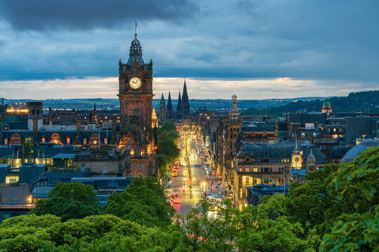 Clock tower of Balmoral Hotel, high angle view of Princes Street and St Mary's Cathedral in background at twilight, UNESCO, Old Town, Edinburgh, Lothian, Scotland, UK