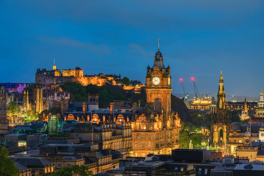 Illuminated Edinburgh Castle, Balmoral Hotel clock tower and Scott Monument seen from Observatory House at dusk, UNESCO, Calton Hill, Edinburgh, Scotland, United Kingdom
