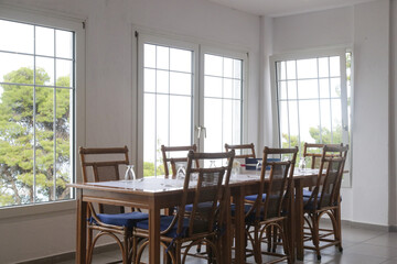 Fototapeta premium Empty seats and tables before dinner time in the indoor restaurant 