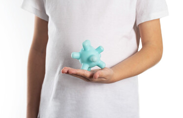 The girl holds a model of the virus against the background of her stomach. Concept of viral...