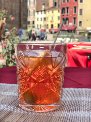 glass of Italian aperol cocktail on table over city view in italy