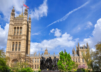 Victoria tower of Westminster Palace (Houses of Parliament) and Burghers of Calais memorial in...