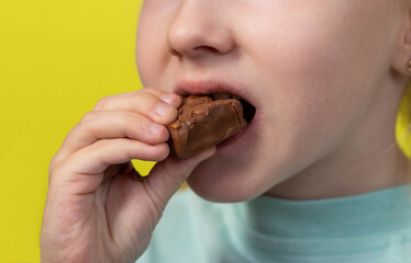 A seven year old little caucasian girl's dirty mouth from eating a candy bar. Diabetes mellitus and glucose. Caries on teeth