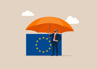 Investor with flag European Union covered by big umbrella. Insurance and finance saving protection in economy crisis in EU, safety investment or all weather portfolio in European Union.
