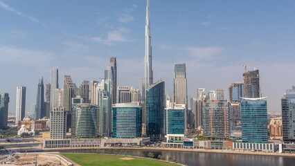 Naklejka premium Aerial view to Dubai Business Bay and Downtown with the various skyscrapers and towers timelapse
