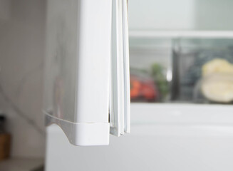 Replacing the torn sealing rubber on the refrigerator door with a new rubber.