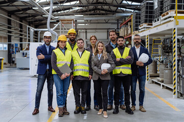 Full team of warehouse employees standing in warehouse. Team of workers, managers, female director...