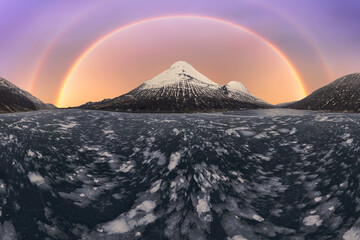 Breathtaking double rainbow over Iceland's frozen landscape