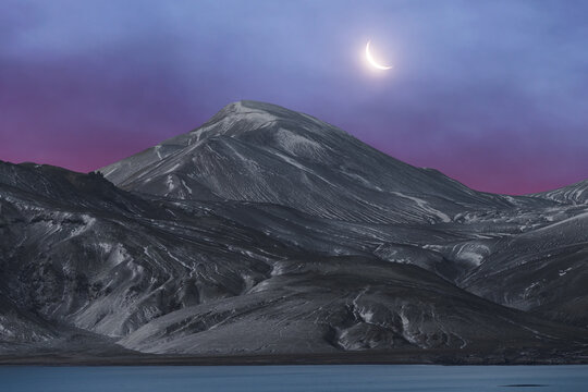 Twilight over Icelandic mountain with crescent moon