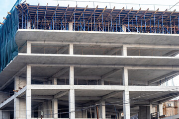 House under construction. Multi-story building without external walls. Architectural industry. Construction monolithic concrete building. Unfinished house. Construction process of high-rise building