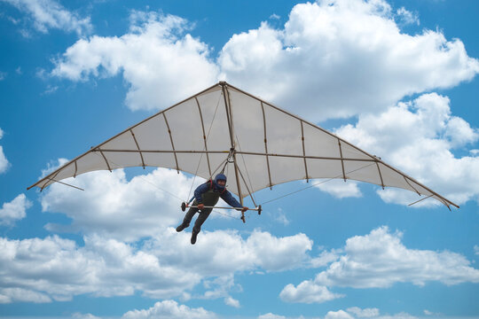 Old vintage hang glider paraglider kite in the sky with clouds