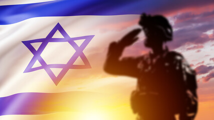 Soldier from Israel. Tsakhal army officer salutes. Israel flag near war. Silhouette of soldier at...