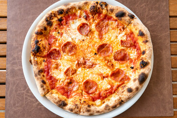 a close up image of a freshly baked Italian style pepperoni pizza 