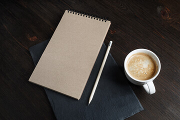Notebook, pencil, coffee cup