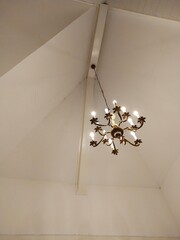 
Chandelier hanging on a white ceiling background