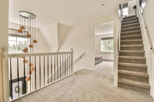 Passage with decor hanging besides railing in villa