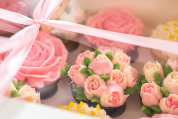 Delicious Gourmet Cupcakes Topped with Buttercream Frosting Flowers
