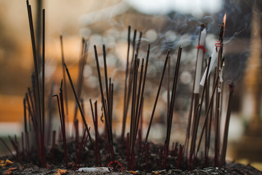 Many incense sticks with smoke in temple in Thailand