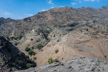 Heavy machinery in the process of mountain road construction works in Saudi Arabia