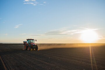 Tractor spreading artificial fertilizers