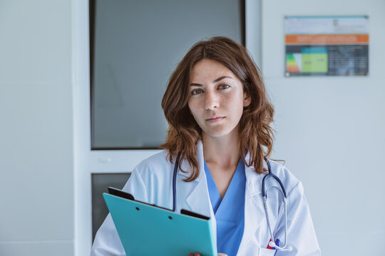 Female doctor in medical uniform with stethoscope and folder at hospital