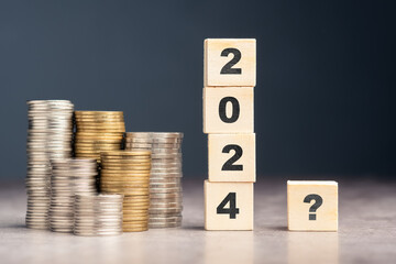 2024 with question mark wood cubes and heaps of money, question for financial plan in coming year,...