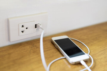 Closeup USB phone direct charging in the USB socket with electricity plug on the wall