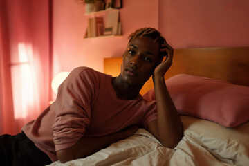 Generative AI image of transgender african person reflecting in bedroom light