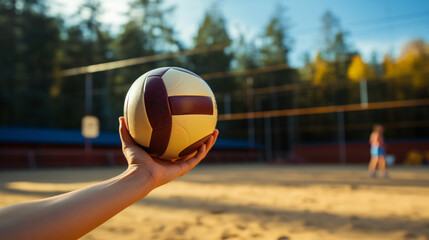 A Person Holding A Volleyball Ball In Their Hand 