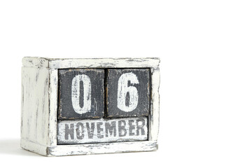 November 06 on wooden calendar, on white background.