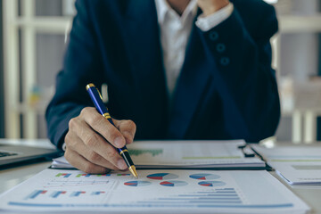 Accountant holding documents preparing performance analysis report Executives create documents at work using online computer software for analyzing financial data. Close-up pictures